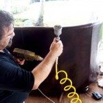 Technician at CCI mends a leather chair 